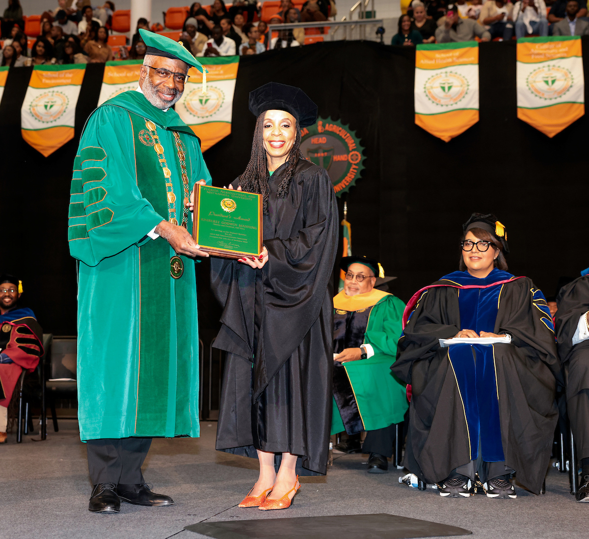 President Robinson presents Kim Godwin the President’’s Leadership Award. She also received a honorary Doctor of Humane Letters